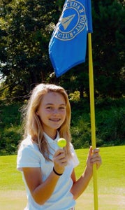 Perfect accuracy: Thirteen-year-old Sydney Grimes of Suffolk holds the ball that she hit 86 yards on Labor Day directly into the hole she’s standing next to at Cedar Point Country Club.