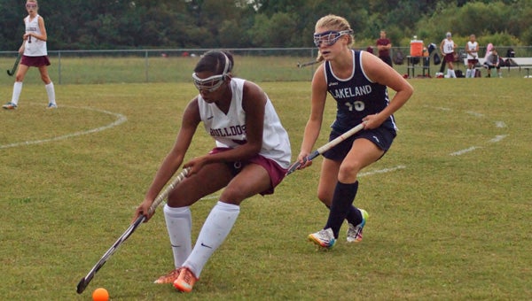 King's Fork High School's Selina Davis steers the ball as sophomore Haley Beale of visiting Lakeland High School approaches on Monday. The Lady Bulldogs beat Lakeland for the first time ever. (Caroline LaMagna photo)