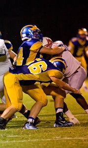 Nansemond-Suffolk Academy senior defensive ends David Gough, No. 44, and Camden Sutton, No. 56, look to take down an opposing player. They will be among the healthy Saints needed tonight. (Janine DeMello photo)