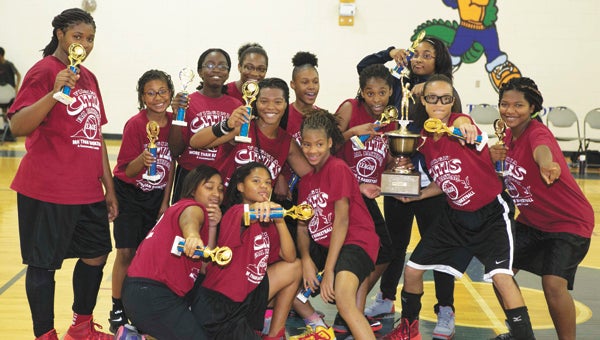 The 2014 Suffolk Lady Storm hold their hard-earned hardware on Saturday after winning the Virginia Cities Fall Basketball League championship. Kneeling, from left: Moriah Johnson and Aleemah Johnson; standing, from left: Nylah Young, Niyah Gaston, Amaya Allen, Ashlee Robertson, Lanae Stokes, Tatianna Johnson, Kayla Hargrove, Makaylen Davis, assistant coach Brianna Copeland, Neecole Brown and Portia Stokes. Not pictured: McKenzie Young. (Photo Submitted by Tom Lewis)