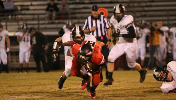 Nansemond River High School junior Chris Henderson goes down after a nice gain against visiting Hickory High School on Friday night. Henderson scored on a 44-yard touchdown reception, helping the Warriors earn a 21-17 win.