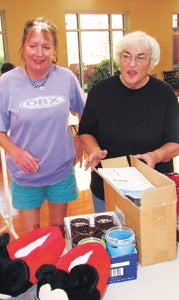 Karen Scott and Lenora Holland sort items on Tuesday for Saturday's "Fabulous Finds" sale at Main Street United Methodist Church.