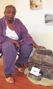 The Rev. Myrtle Hatcher shows off bricks from the foundation of Main Street United Methodist Church’s first site farther north from its current location on North Main Street. The 213-year-old church is celebrating 100 years of its current building beginning this Sunday.