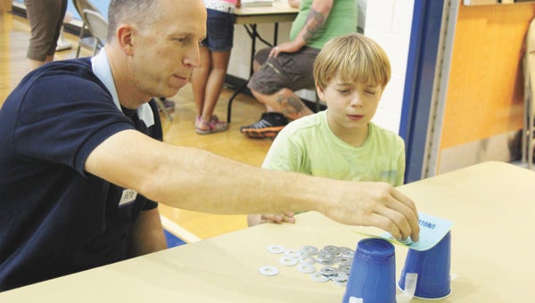 During Family Engineering Night at Hillpoint Elementary School on Tuesday, Pete Clemow explores a station with his son, fourth-grader Robert. In all, 260 RSVPs were received for the educational evening.