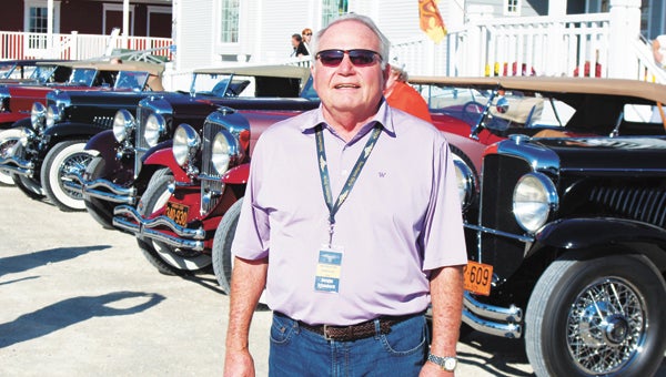 North Suffolk’s Dwight Schaubach — who co-organized a tour for owners and owns two of them himself — stands in front of more than a dozen Duesenbergs lined up outside Smithfield Station on Tuesday. Owners have come from across America to base themselves in Williamsburg and tour the region for several days.