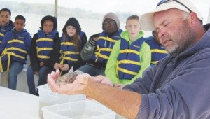 Chesapeake Bay Foundation educator Yancey Powell shows a critter to King’s Fork Middle School students.