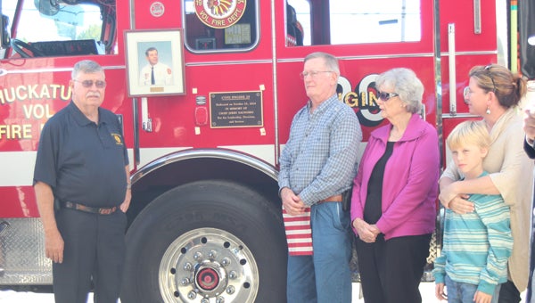 During Chuckatuck Founder’s Day celebrations Saturday, at the Chuckatuck Volunteer Fire Department building, Vernon Gayle, Bill Saunders, Iola Saunders, Wendy Spain and James Spain, 9, participate in the dedication of Engine 29 to the late Jerry Saunders, who was a 60-year veteran of the volunteer organization.