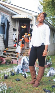 Tealayshia Porter smiles for the camera in the yard her aunt, Diana Jones, decorated for Halloween.