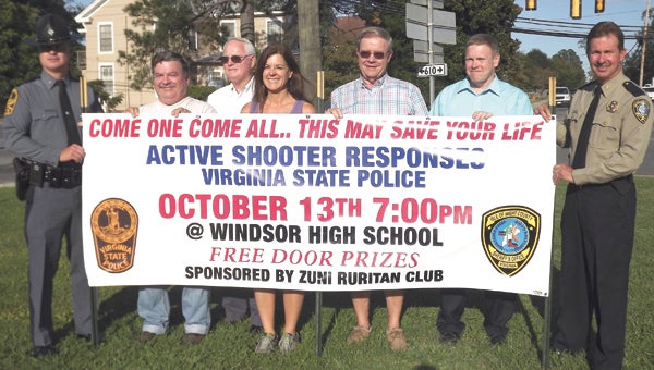 From left, Virginia State Trooper Lt. Curtis Hardison, Buddy Doxie, Thomas Hardison, Tammy Edwards, Charles Powell, Tom Michaels and Isle of Wight County Sheriff Mark Marshall promote a meeting about active shooter responses next week.