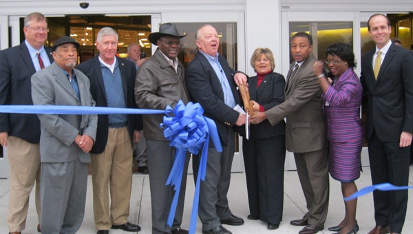 A large contingent of Suffolk City Council members, including Charles Parr, Curtis Milteer, Charles Brown, Mayor Linda Johnson and Lue Ward, attended a ribbon-cutting ceremony Wednesday for the new Kroger Marketplace in North Suffolk. Johnson is on one side of the scissors with store manager Ricky Green, while City Manager Selena Cuffee-Glenn and John Peterson III, vice president of Hampton Roads Crossing developer The Terry Peterson Companies, are on the far right. (Submitted photo by Suffolk Department of Economic Development)