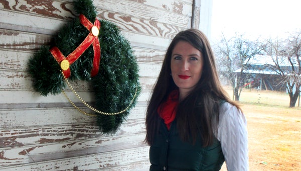 At her family’s Chuckatuck farm, Joanna Bickham shows an example of the Christmas wreaths shaped like horse heads with which she has raised about $1,000 for ReRun Inc., a Suffolk-based thoroughbred horse rescue.