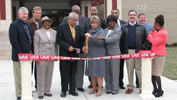 City Council members and other officials prepare to cut the ribbon Friday at the Whaleyville Community Center. From left are Councilmen Roger Fawcett and Tim Johnson; Obici Healthcare Foundation board member Lula Holland; Councilman Curtis Milteer; Vice Mayor Leroy Bennett; Mayor Linda T. Johnson; Buildings and Capital Programs Director Gerry Jones; City Manager Selena Cuffee-Glenn; Councilmen Lue Ward, Mike Duman and Don Goldberg; and Parks and Recreation Director Lakita Watson.