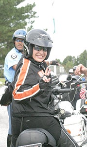 Lynette White prepares to set off on a Swamp Roar motorcycle ride. The event, her brainchild during her employment with the city, benefits programs of the Great Dismal Swamp National Wildlife Refuge.