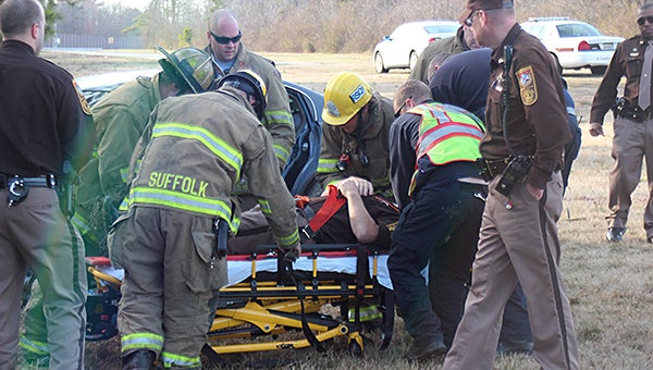 Firefighters and sheriff’s deputies assist a deputy who was injured while trying to help the victims in a single-vehicle accident on Carolina Road Thursday afternoon.
