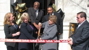 Mayor Linda T. Johnson helps Ann Langston, far left, and Ann Tucker cut the ribbon in front of Tower 112 with Councilman Don Goldberg, far right, holding the ribbon. In back are Vice Mayor Leroy Bennett, left, and Councilman Lue Ward.