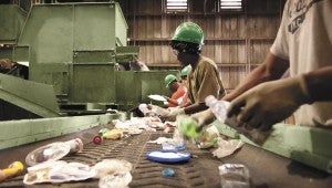 Employees at TFC Recycling sort items on a conveyor belt. A combination of humans and machinery separate the many different types of recyclables into groups so they can be baled and sold. (Submitted Photo)