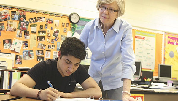 Lakeland High School’s Catherine Williams, this week named the 2015 Suffolk Public Schools Citywide Teacher of the Year, offers some advice to Emmanuel Costa, an exchange student from Brazil.