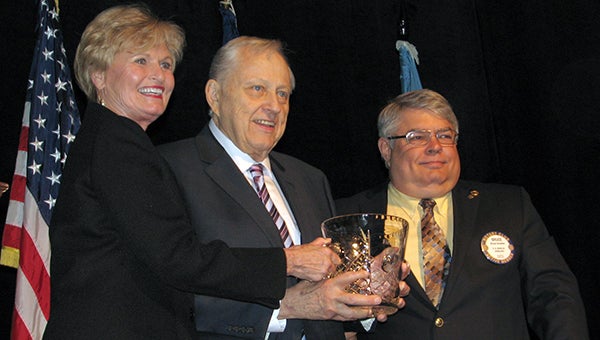 Robert W. Harrell Jr. receives the 2014 First Citizen award from Wendy Hosick, left, president of the Rotary Club of North Suffolk, and Bruce Bowles, right, president of the Suffolk Rotary Club.