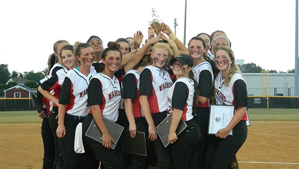 The Nansemond River High School softball team holds up the trophy it earned on Thursday after defeating King’s Fork High School 3-1 in the Ironclad Conference tournament.