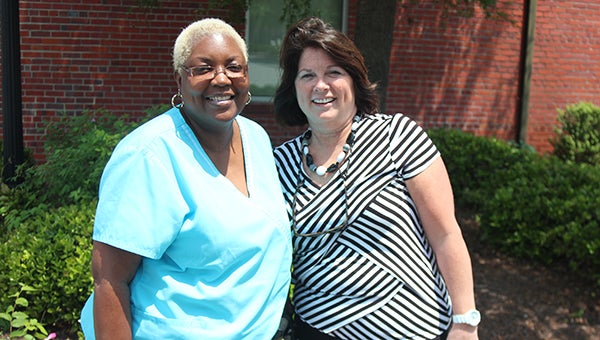 Vondelear Barnes, left, has been diagnosed with ALS. Janice Woodard, right, her work colleague at Suffolk Pediatrics, is helping raise awareness about the disease in the local area.