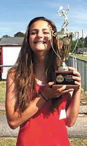 Nansemond River High School sophomore tennis star Erin Bonney holds the trophy for the Ironclad Conference team tournament championship she helped the Lady Warriors win recently. By winning the conference singles and doubles tournaments the next week, she became the Duke Automotive-Suffolk News-Herald Player of the Week.