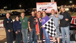 Robbie Babb celebrates in Victory Lane with his wife, other family and crew members after his win in the second of the twin 30-lap events in the Modifieds class of NASCAR’s Whelen All-American Series races on Saturday at Langley Speedway. (Bill Carr/MotorSports Photo News Service)
