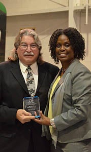 Louis Garland, co-sponsor of John Yeates Middle School’s CHROME Club, celebrates with Aliecia McCain, chairperson of the Cooperating Hampton Roads Organizations for Minorities in Engineering board of directors, after Suffolk students scooped several top honors at the 30th Anniversary STARS Awards. 