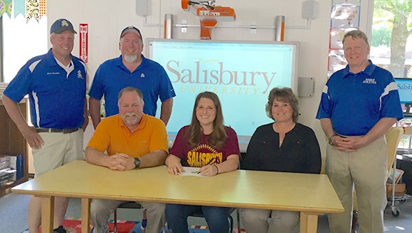 Southampton Academy star pitcher Brooke Mizelle recently signed to play for Salisbury University, flanked by her parents, Barry and Patty Mizelle, who were present along with Lady Raiders coaches Jeb Bradshaw, Scott Speight and SA athletics director Dale Marks. (Photo submitted by Anne Pittman)