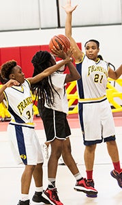 Latrina Cross, left, and Karisma Harrison, right, of the Paper City Ballers compete against a team from Salisbury, Md. on Saturday at the Salvation Army gym during Britt-Quinn Enterprise, Inc.’s fourth annual Communities Coming Together event.