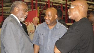 Vice Mayor Leroy Bennett chats with Derek and Greg Porter, brothers who are among the new employees of the Friant & Associates facility off Holland Road.