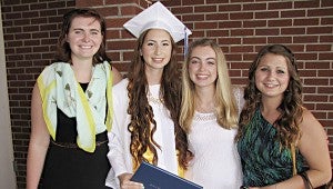 From left, Melody Brown, Zoe Waddell, Ashley Barton and Julia Jackson celebrate after Suffolk Christian Academy’s graduation on Saturday. Waddell and Barton were among the 12 graduates.