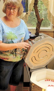 Cindy Quesenberry shows off the inside of one of her smaller kilns