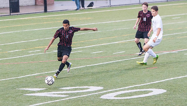 Nansemond River High School freshman defender Maycol Reyes clears the ball against Jamestown High School during the Region 4A South semifinals. Reyes recently became the first Warriors boys' soccer player to make the all-state first team. Teammates Brayan Morales and Axel Lopez made the all-state second team.