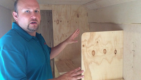 Chris Johnson, founder and president of Legacy Limousines and Luxury Coaches, shows off the first step of constructing a bus’s interior. After making sure the plywood pieces fit, Johnson and his crew cover the plywood and make an interior.