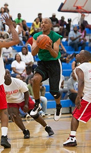 Former NBA and Forest Glen High School player Lamont Strothers looks for someone to pass to against Suffolk High School during last year's Old School Classic at Lakeland High School.  He will be back this year along with a host of local players from the late '80s and early '90s.