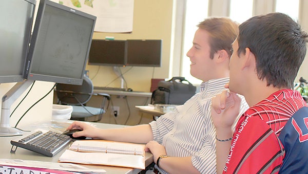 Jared Goldbach Ehmer, left, works in the University of Richmond’s Spatial Analysis Lab during a summer fellowship.