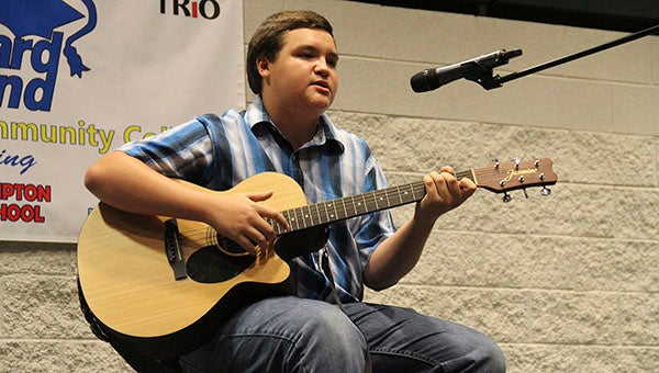 Rising Lakeland High School junior Brandon Coker performs on guitar for the audience during an Upward Bound closing ceremony recently.