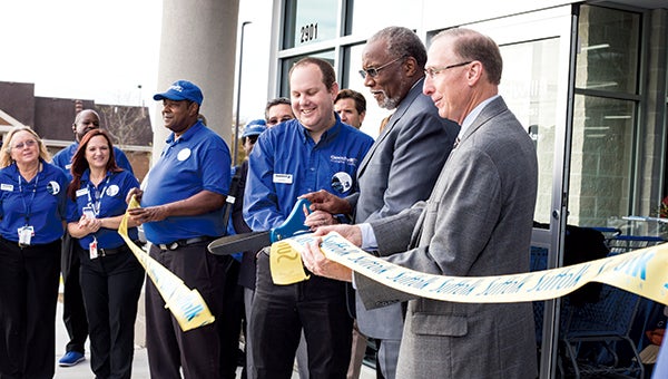 Goodwill district manager Andrew Hardymon, left, is joined Thursday by Suffolk Vice Mayor Leroy Bennett, center, Goodwill chief executive officer Charles Layman and other company and city officials during a ribbon-cutting ceremony at the nonprofit company’s newest store, located on Godwin Boulevard. 