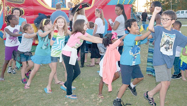 Children join a conga line around an inflatable pirate ship at a previous Chesapeake Parks and Recreation “Movies and More” event. This Saturday’s event will include tennis led by two people with connections to Suffolk.