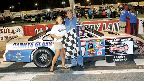 Danny Edwards Jr. celebrates with trophy presenter Stephanie LaPoint after his win in the first twin 65-lap Late Model Stock Cars event of the NASCAR Whelen All-American Series at Langley Speedway in Hampton on Saturday (Bill Carr/MotorSports Photo News Service)