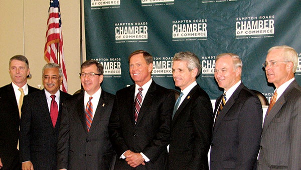Posing for a group photo during the Hampton Roads Chamber of Commerce’s congressional forum Wednesday at the Chesapeake Conference Center are, from left, Rep. Rob Wittman, Rep. Bobby Scott, Chamber Board of Directors Chair Joe Witt, Chamber President and Chief Executive Officer Bryan Stephens, Rep. Scott Rigell, Rep. Randy Forbes and Charlie Henderson, Hampton Roads market president of Bank of America, the event’s presenting sponsor.