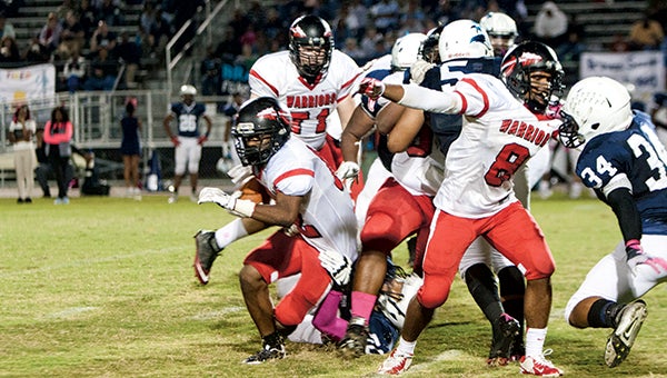 Nansemond River High School senior running back Terrence Lambert drives wide with the ball as senior wide receiver Chris Henderson, No. 8, blocks against host Indian River High School on Tuesday night. The Warriors had a strong second half, but they could not overcome the Braves’ strong first half, leading to a 41-13 defeat.