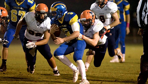 Nansemond-Suffolk Academy senior running back Graham Moore pesters the defense of visiting Norfolk Academy on Friday night. Moore and the Saints made the most of their homecoming game, blowing out the Bulldogs 42-7. (Janine DeMello photo)