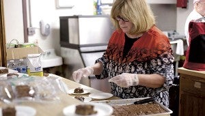 Ann Doughtie prepares a meal for visitors to the Salvation Army on a recent Thursday.