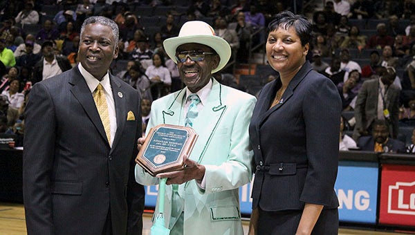 Mr. CIAA, Abraham Mitchell, is set to be inducted into the Central Intercollegiate Athletic Association in February. He is pictured receiving an award from the athletic conference in 2012 from Dr. Mickey Burhim, left, president of Bowie State University and chairman of the CIAA board of directors, and Peggy Davis, right, interim commissioner of the CIAA.