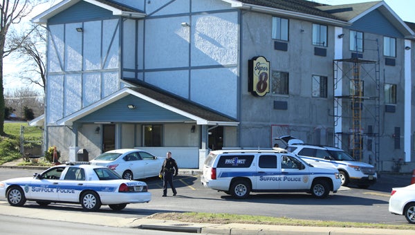 Police work the scene of a man shot at the Super 8 Motel on North Main Street Tuesday morning.