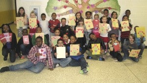 Students from Elephant’s Fork Elementary School deliver valentines to Suffolk Sheriff’s Deputy Sandy Toby, in the back row, to be handed out to residents at Autumn Care. In back, from left, are Anna Gomer, Storey Grooms, Caden Randall, Christian Randall, Deputy Toby, Kenzie Mast, Sophia Wilkerson, Jordan Pridgen, Tatum Reiken, Ashlyn Dailey, Jaravion Faulk, Madison Pursel, Javion Wilkerson and Brandon Major. In the middle, from left are De'Ryah Artis, Maurice Dixon, Shamar Ward,Mar'Kasia Morrow, Mark'Keana Morrow, Assata Horne, Authenic Smallwood, Joey Lowry and Shymik Robinson. In front, from left, are Duntoris Hawkins, Yair Garcia and N'ky Benjamin.