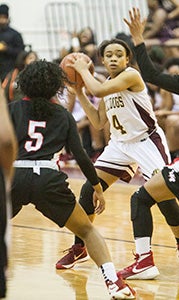 King’s Fork High School sophomore point guard Camary Harris looks for a crack in the defense of visiting Lake Taylor High School during the Conference 17 tournament semifinals on Wednesday. Harris helped key a 67-51 season-saving win for the Lady Bulldogs.