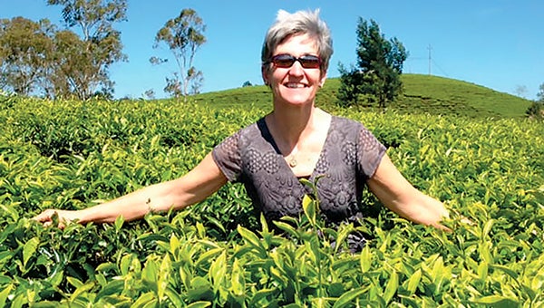 Suffolk farmer Shelley Barlow stands in a field of tea leaves in Vietnam. The trip was part of VALOR, an agricultural leadership program offered through Virginia Tech. (Submitted Photo)