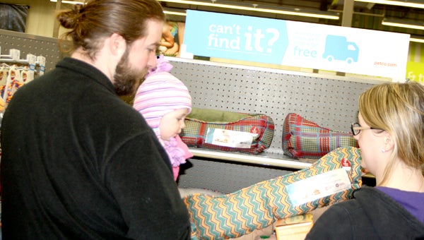 Megan and Scott Horne, with 7-month-old daughter Lahna, shop for a new dog bed at the new Petco in North Suffolk.